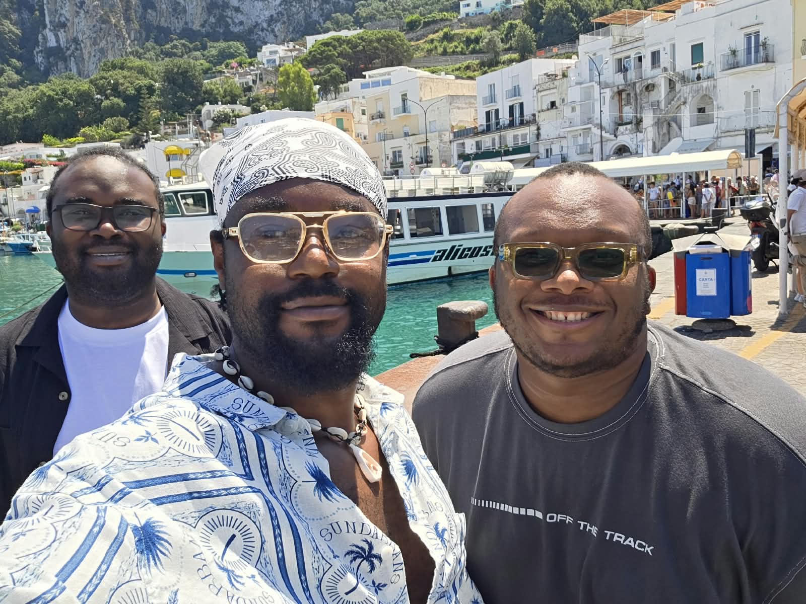 Three friends smiling together during their journey